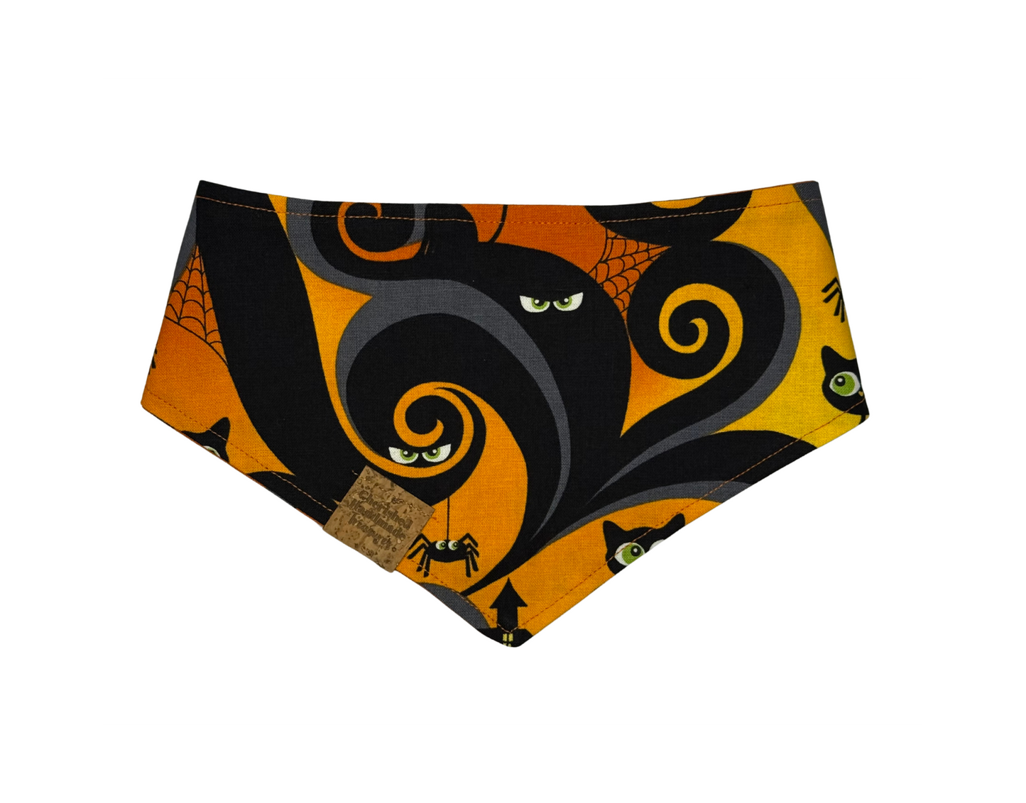 A triangular pet bandana featuring a Halloween-themed print with a large black cat silhouette, orange swirls, spiderwebs, spiderbugs, and cat faces on a bright orange background.
